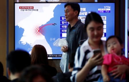 People watch a TV broadcast of a news report on North Korea firing short-range ballistic missiles, in Seoul