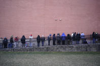 People wait in line for the COVID-19 vaccine in Paterson, N.J., Thursday, Jan. 21, 2021. The first people arrived around 2:30 a.m. for the chance to be vaccinated at one of the few sites that does not require an appointment. (AP Photo/Seth Wenig)