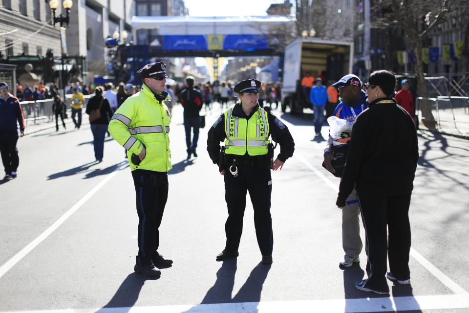 Police stand by near the finish line ahead of Monday's 118th Boston Marathon, Sunday, April 20, 2014, in Boston. Massachusetts Gov. Deval Patrick says officials are striking a balance between more security and maintaining the city's festive spirit. (AP Photo/Matt Rourke)