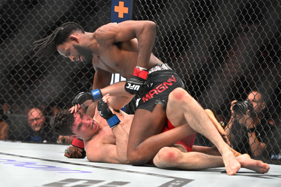 Jan 20, 2024; Toronto, Canada, USA; Neil Magny (red glove) fights Mike Malott (blue gloves) during UFC 297 at ScotiaBank Arena. Mandatory Credit: Dan Hamilton-USA TODAY Sports