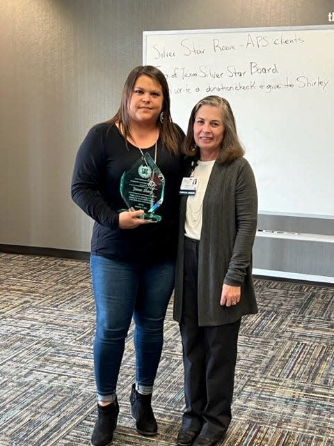 D'Ann Berry, right, presents the Jim Holston Community Service Award to Jaime Sharp at the Senior Ambassadors Coalition's annual Christmas luncheon Dec. 9 in The Commons Room of Central Church of Christ.