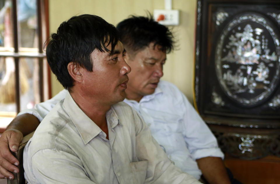 Doan Van Binh, brother and Doan Van Thanh, father of Doan Thi Huong, talk to reporters at his house in Nghia Binh village, Nam Dinh province, Vietnam, Thursday, Aug. 16, 2018. Doan Thi Huong, and Indonesian Siti Aisyah, who are on trial in the assassination of the North Korean leader's half brother have told the court they will testify in their defense. The women are accused of smearing VX nerve agent on Kim Jong Nam's face last year. They have said they thought it was a prank. A judge ruled Thursday the women should begin entering their defense.( (AP Photo/ Hau Dinh)