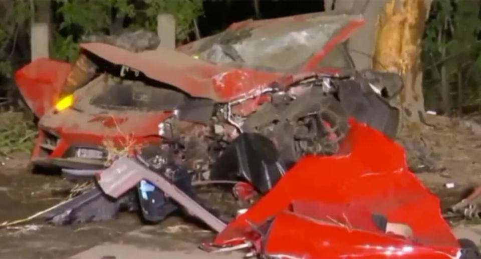 The crumpled wreckage of the Lamborghini after it crashed into a tree.