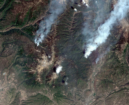 A satellite image shows the Burro Wildfire (L) and the 416 Wildfire burning west of Highway 550 and northwest of Durango, Colorado, U.S., June 9, 2018. Image captured June 9, 2018. Satellite image ©2018 DigitalGlobe, a Maxar company/Handout via REUTERS