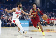 Cleveland Cavaliers' Darius Garland (10) drives on Chicago Bulls' Coby White (0) in the first half of an NBA basketball game, Saturday, Jan. 25, 2020, in Cleveland. (AP Photo/Ron Schwane)