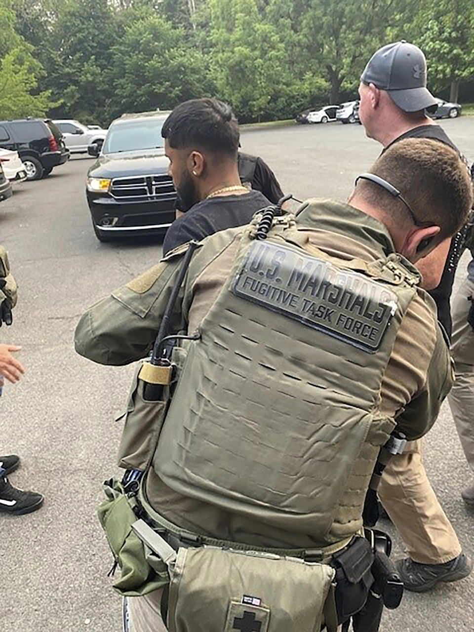 This photo provided by the U.S. Marshals Service shows officers arresting Ivan Claudio Rosero in Philadelphia, Tuesday, June 6, 2023. The fugitive wanted in the fatal shooting of three people, including two children who’d been playing with kittens in the back yard of their Pennsylvania home, has been captured in Philadelphia, federal officials said Wednesday. (U.S. Marshals Service via AP)