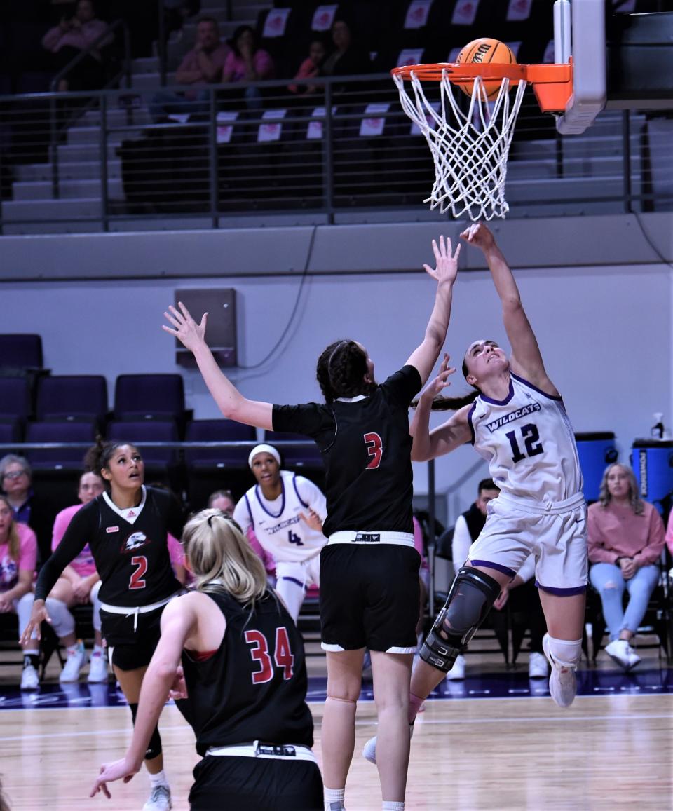 ACU's Addison Martin (12) drives to the basket as Southern Utah's Megan Jensen (3) defends in the second half.