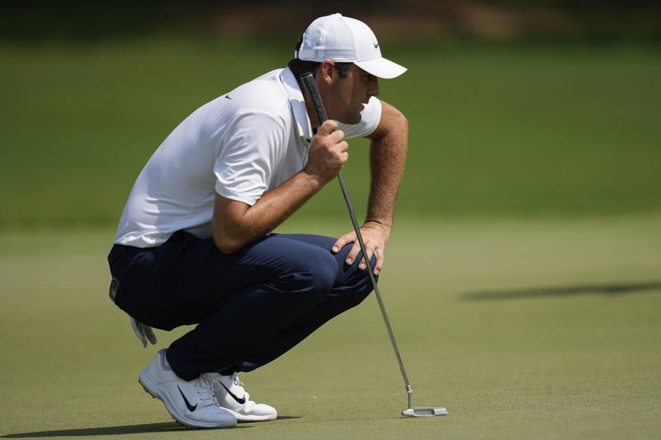 Scottie Scheffler lines up a putt on the seventh green during the second round of the Tour Championship golf tournament, Friday, Aug. 25, 2023, in Atlanta. (AP Photo/Mike Stewart)