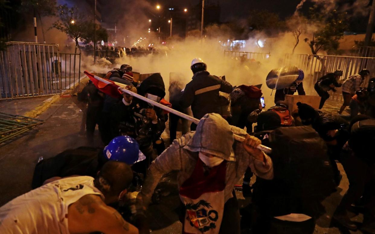 Demonstrators clash with police during a protest against the decision of Congress to remove former President Martin Vizcarra, in Lima - Reuters