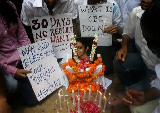 Indian schoolchildren gather with placards and lighted candles around a picture of slain classmate Aarushi Talwar during a rally in New Delhi in 2008. A murder case that has obsessed India for four years will come to court on Friday when a middle-class couple from Delhi stand trial on charges of killing their teenage daughter and domestic servant