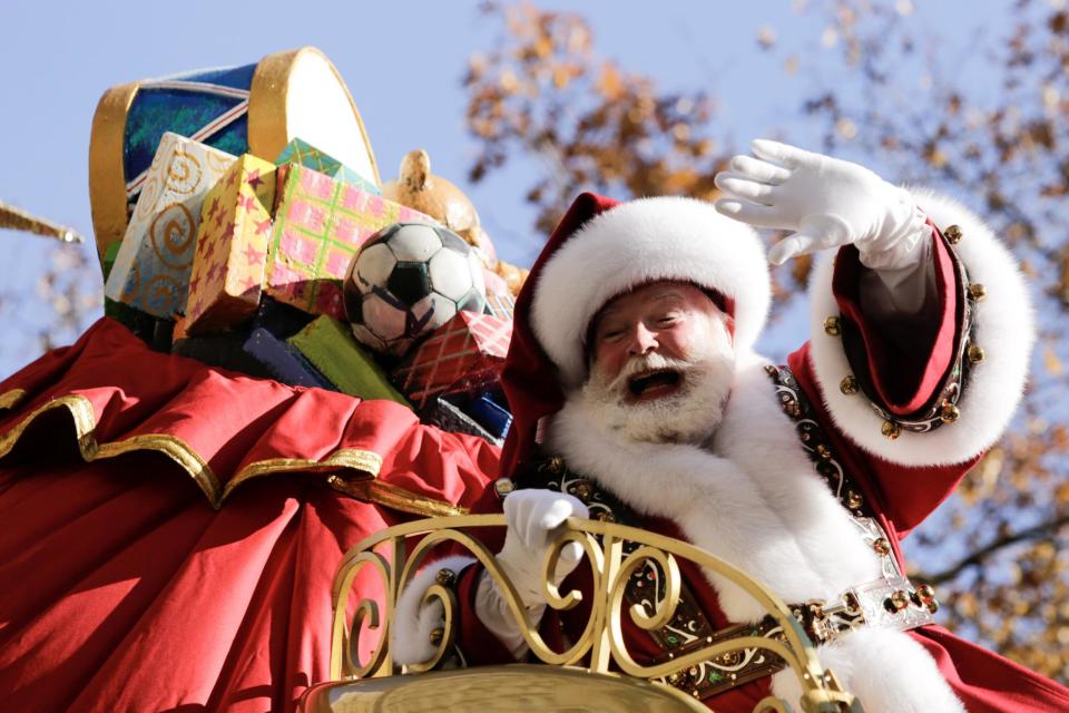 Father Christmas makes his way down Central Park West (Reuters)