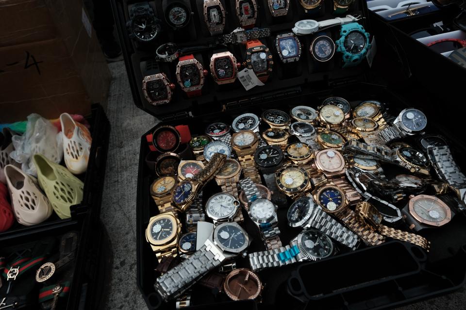 NEW YORK - JUNE 22: Knock-off luxury watches are displayed by sellers along a sidewalk on Canal Street in Manhattan on June 22, 2023 in New York City. Online marketplaces are now putting new policies in place to crackdown on sale of stolen and counterfeit goods, too. According to the U.S. Intellectual Property and Counterfeit Goods Office, the value of the international counterfeit luxury items market is estimated to be between $400 billion to $600 billion. (Photo by Spencer Platt/Getty Images)