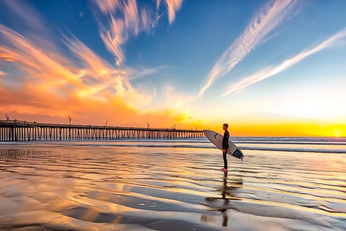 Surfer near the pie in Pismo Beach