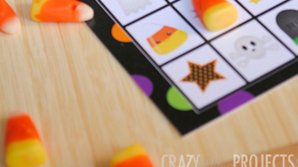 halloween themed bingo cards with squares marked off with pieces of candy corn for halloween activity