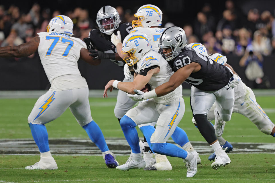 LAS VEGAS, NEVADA – DECEMBER 14: Quarterback Easton Stick #2 of the Los Angeles Chargers is sacked by defensive tackle Jerry Tillery #90 of the Las Vegas Raiders during the first quarter at Allegiant Stadium on December 14, 2023 in Las Vegas, Nevada. (Photo by Ethan Miller/Getty Images)