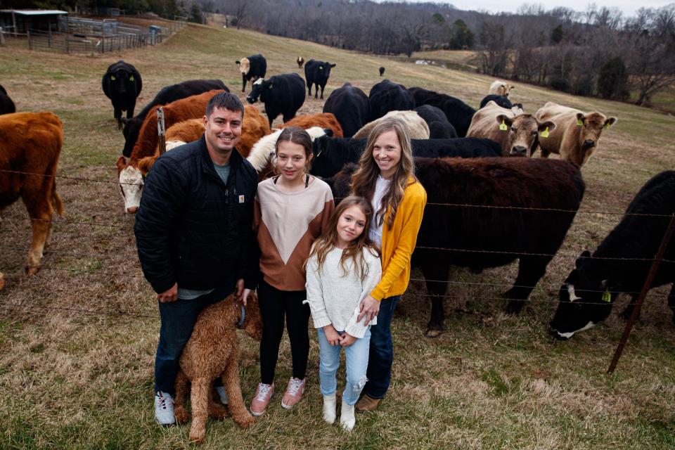 From left to right, Ryan, Katelyn, Makayla and Megan Heichelbech stand in front of their cattle on their farm in Culleoka, Tenn. on Jan. 24, 2023.