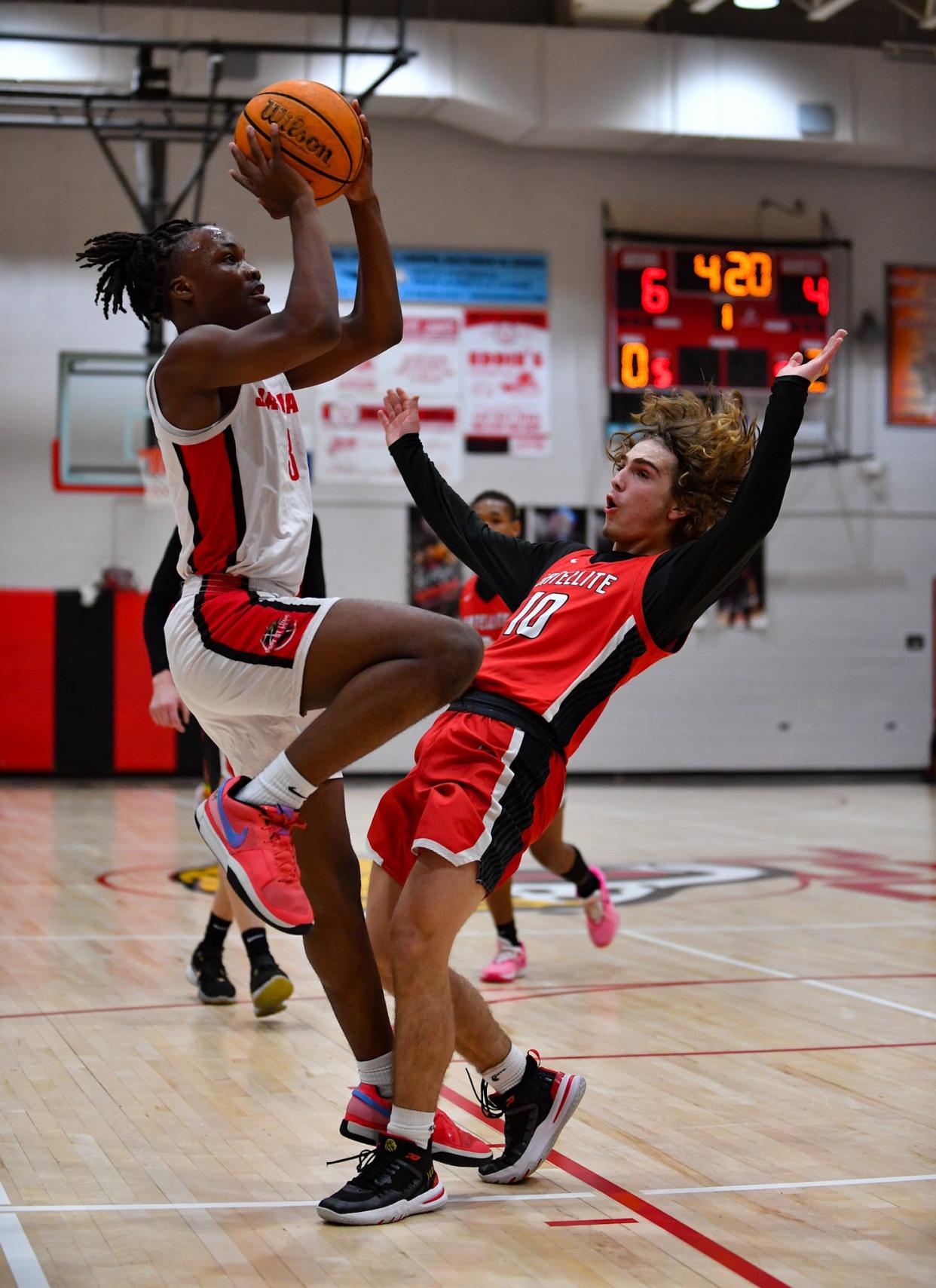 Port St Lucie’s Makhari Chambliss (3) shoots over Satellite’s K’dynce Cataldo (10) in a boys high school basketball quarterfinal, Thursday, Feb. 8, 2024, in Port St. Lucie.