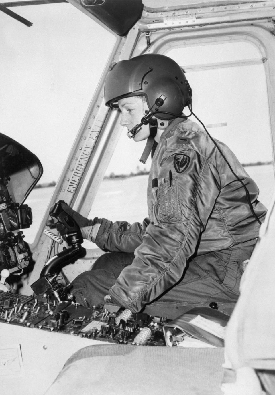 Sally D. Murphy, 25, at the controls of the UH-1 'Huey' helicopter, is recognized in the U.S. Army as its first woman aviator and also its first military helicopter pilot.