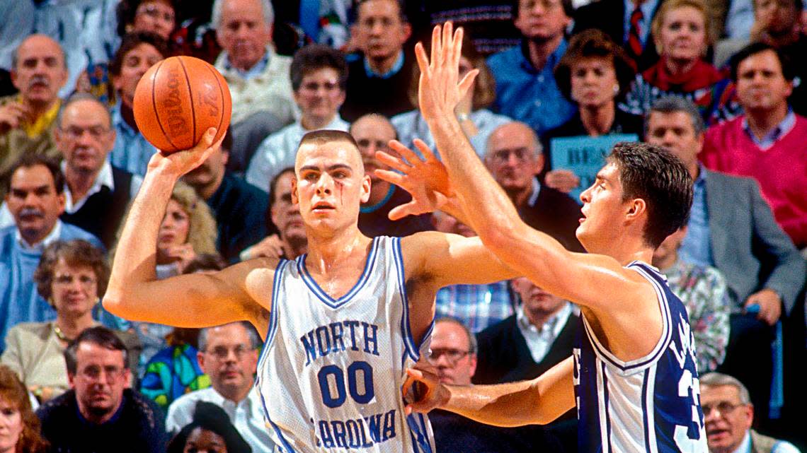 North Carolina Tar Heels center Eric Montross (00) looks to pass as Duke Blue Devils center Christian Laettner (32) defends in the Tar Heels 75-73 victory against the Blue Devils at the Dean E. Smith Center. Montross is playing with a cut below his left eye.