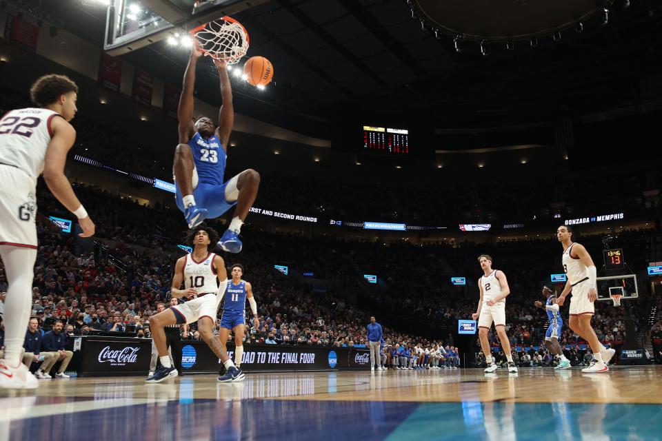 PORTLAND, OREGON - MARCH 19: Malcolm Dandridge #23 of the Memphis Tigers dunks the ball during the first half against the Gonzaga Bulldogs in the second round of the 2022 NCAA Men's Basketball Tournament at Moda Center on March 19, 2022 in Portland, Oregon. (Photo by Ezra Shaw/Getty Images)