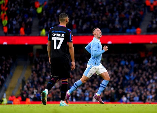 Phil Foden celebrates scoring against Huddersfield