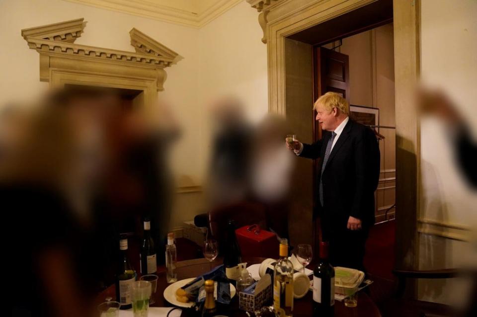 Photographs of Boris Johnson drinking at a staff leaving do were published as part of Sue Gray’s report into lockdown parties (Sue Gray Report/Cabinet Office/PA) (PA Media)