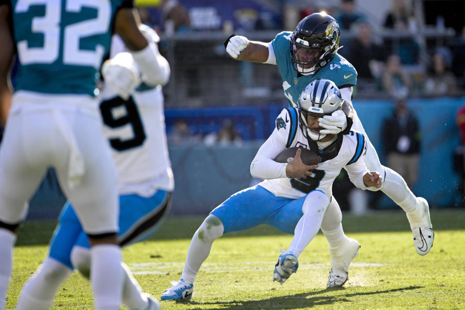 Carolina Panthers quarterback Bryce Young is sacked by Jacksonville Jaguars linebacker Travon Walker during the second half of an NFL football game Sunday, Dec. 31, 2023, in Jacksonville, Fla. (AP Photo/Phelan M. Ebenhack)
