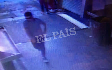 A watermarked CCTV frame grab provided by Spanish newspaper El Pais shows a suspect walking through La Boqueria market seconds after a van crashed into pedestrians in Barcelona, Spain, August 17, 2017. Courtesy of El Pais via REUTERS