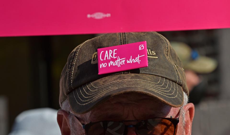 A demonstrator at a May 3 Sarasota Save Roe Response protest in Florida wears a badge bearing one of Planned Parenthood's slogans: "Care. No matter what."