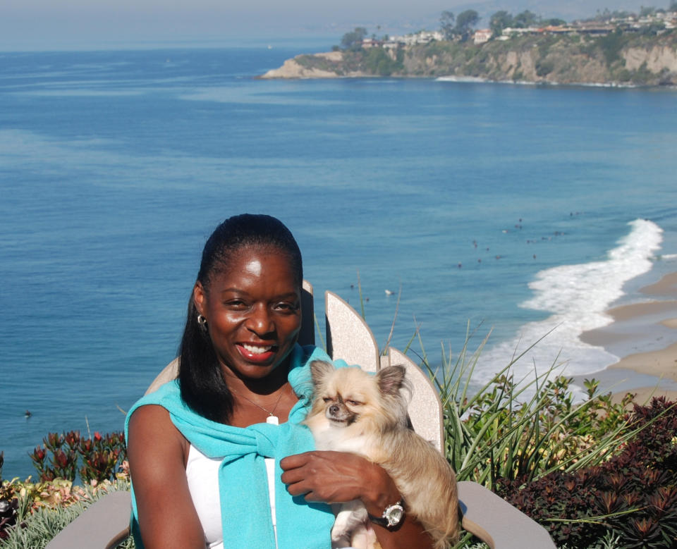 This Oct. 28, 2011, photo provided by The Jet Set Pets shows Kelly E. Carter, founder of The Jet Set Pets, posing with her longhair Chihuahua, Lucy, at the Ritz-Carlton, Laguna Niguel in Dana Point, Calif. Travel for humans during holidays is tough enough: Long lines, crowds everywhere, extra bags full of presents. Throw a pet in the mix, and it's a recipe for disaster. "Some dogs don't like to travel, some love it," she said. "You have to know your pet." (AP Photo/The Jet Set Pets, Regina DiMartino)