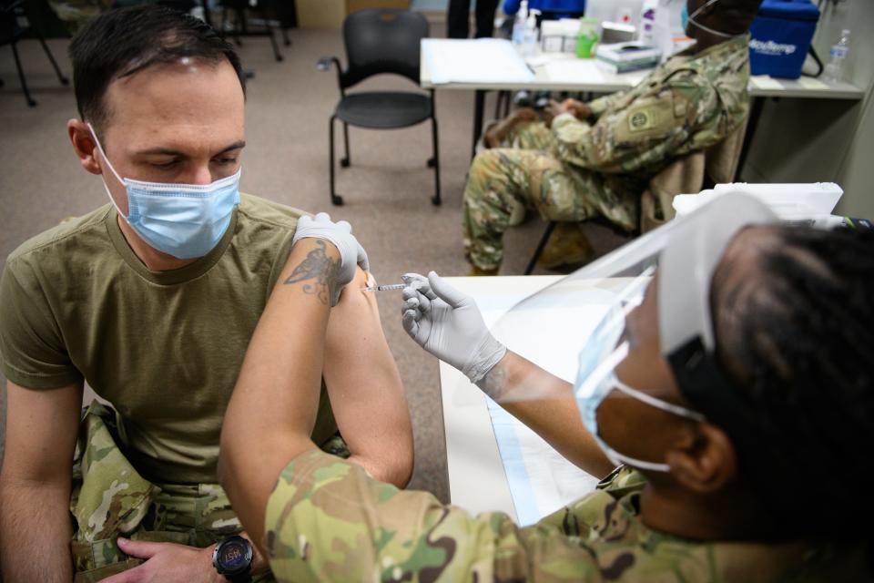 Maj. Nathan Wagner receives a COVID-19 vaccination from Sgt. Paula Smith at Fort Bragg in December 2020. The Army estimates that nearly 1,300 soldiers have separated because of refusing the vaccine.