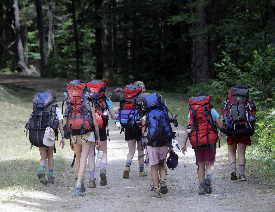 In this Tuesday, July 30, 2013 photo, campers from North Country Camps in Keeseville, N.Y., hike the road to Camp Santanoni, an Adirondack great camp that is being restored, in Newcomb, N.Y. Santanoni was one of the earliest great camps built by wealthy families with names like Rockefeller and Vanderbilt beginning in the late 19th century. Managed by state environmental officials, it is the only remaining great camp that is publicly owned. (AP Photo/Mike Groll)