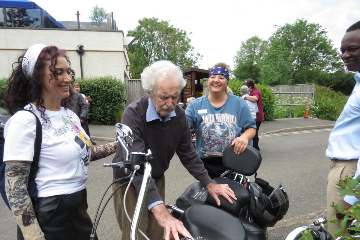 Fernhill resident Nigel Gullis has a hands-on look at a bike with, from left: Companionship Team Leader Cara Duroe, Nurse Agi Ciok and Home Manager Francis Bosompim. <i>(Image: Colten Care)</i>