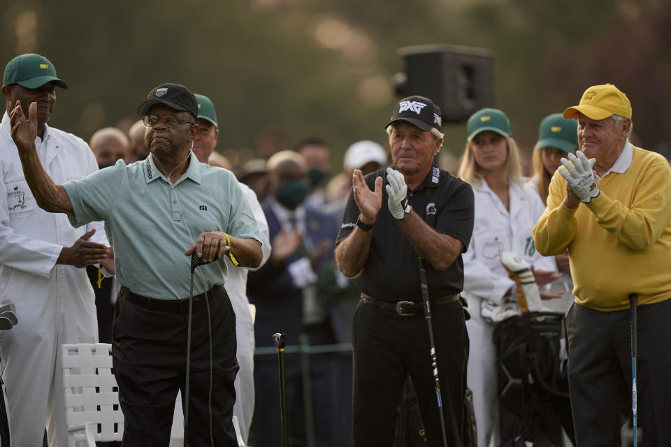 Gary Player, center, and Jack Nicklaus applaud as Lee Elder, left, waves before the ceremonial first tee shot at the Masters golf tournament on Thursday, April 8, 2021, in Augusta, Ga. (AP Photo/Matt Slocum)