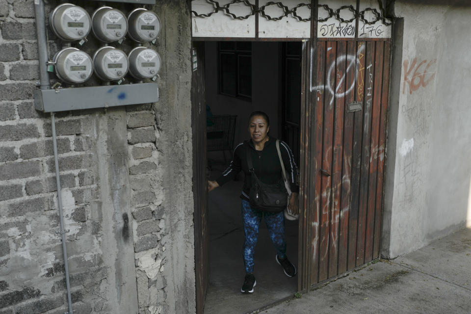Domestic worker Concepcion Alejo walks out of her apartment as she heads to the gym before going to work, in Mexico City, Wednesday, April 24, 2024. Alejo is among approximately 2.5 million Mexicans — largely women — who serve as domestic workers in the Latin American nation. (AP Photo/Marco Ugarte)