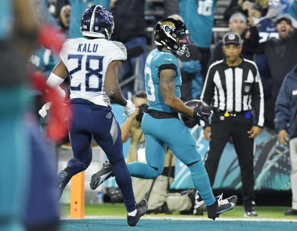 Jacksonville Jaguars wide receiver Christian Kirk (13) takes a pass from quarterback Trevor Lawrence (16) into the end zone for a second quarter touchdown.