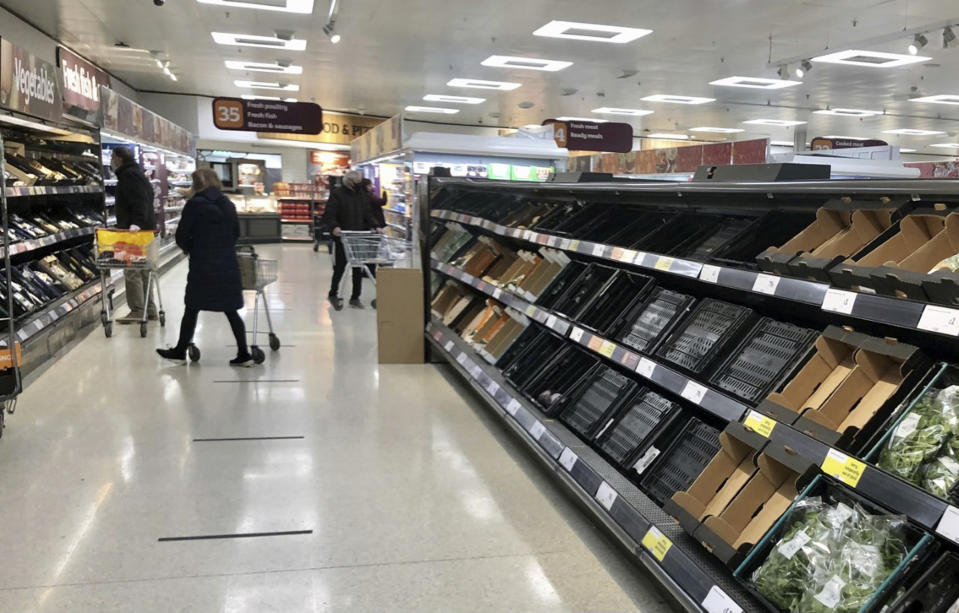 Depleted shelves are seen in a Sainsbury's supermarker at the Forestside shopping centre in Belfast, Monday, Jan. 11, 2021. The U.K.’s biggest supermarket chains warned Wednesday, Jan. 13 that food supplies in Northern Ireland face disruption because of new checks imposed by Britain’s departure from the European Union. After photos emerged showing empty shelves, the chief executives of Tesco, Sainsbury's, Asda, Iceland, Co-Op and Marks & Spencer wrote to the government saying there would be “significant disruption” unless urgent action was taken to fix an “unworkable” system. (David Young/PA via AP)