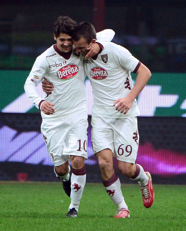 Torino's forward Riccardo Meggiorini (R) celebrates after scoring his second goal during the serie A match between Inter Milan and Torino on January 27, 2013 at the San Siro stadium in Milan. The match ended in a 2-2 draw