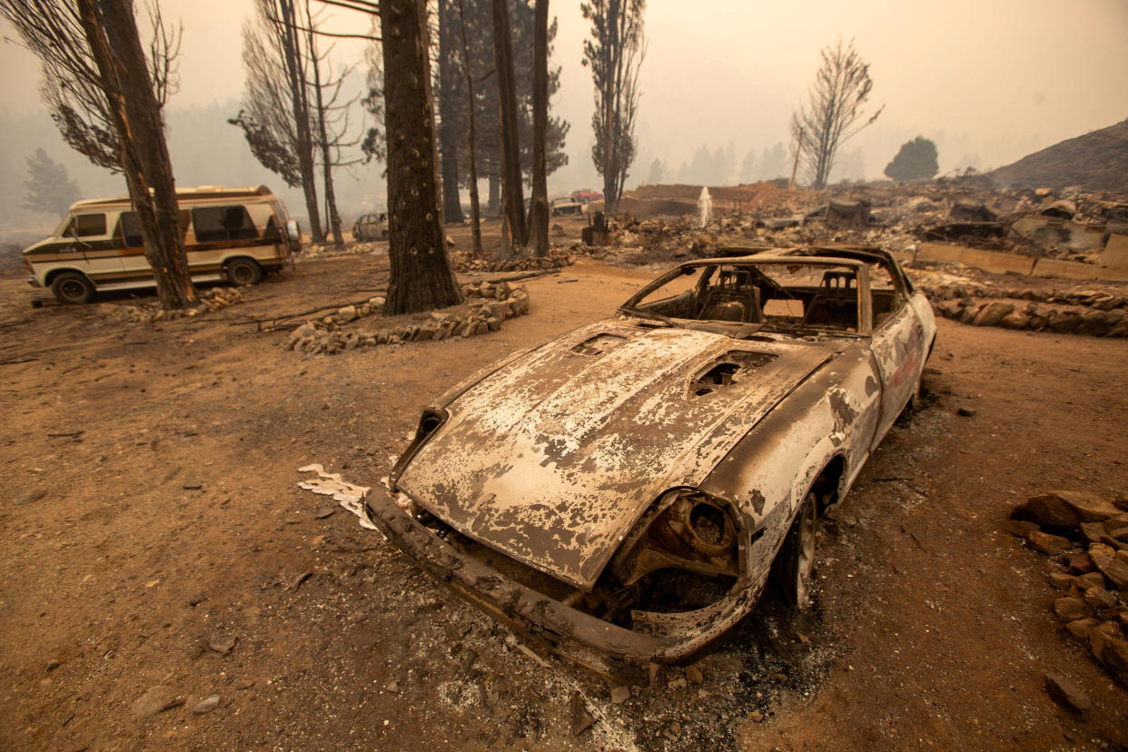 A burned-out car is seen after the Bridge Fire tore through Wrightwood, Calif., on Wednesday.