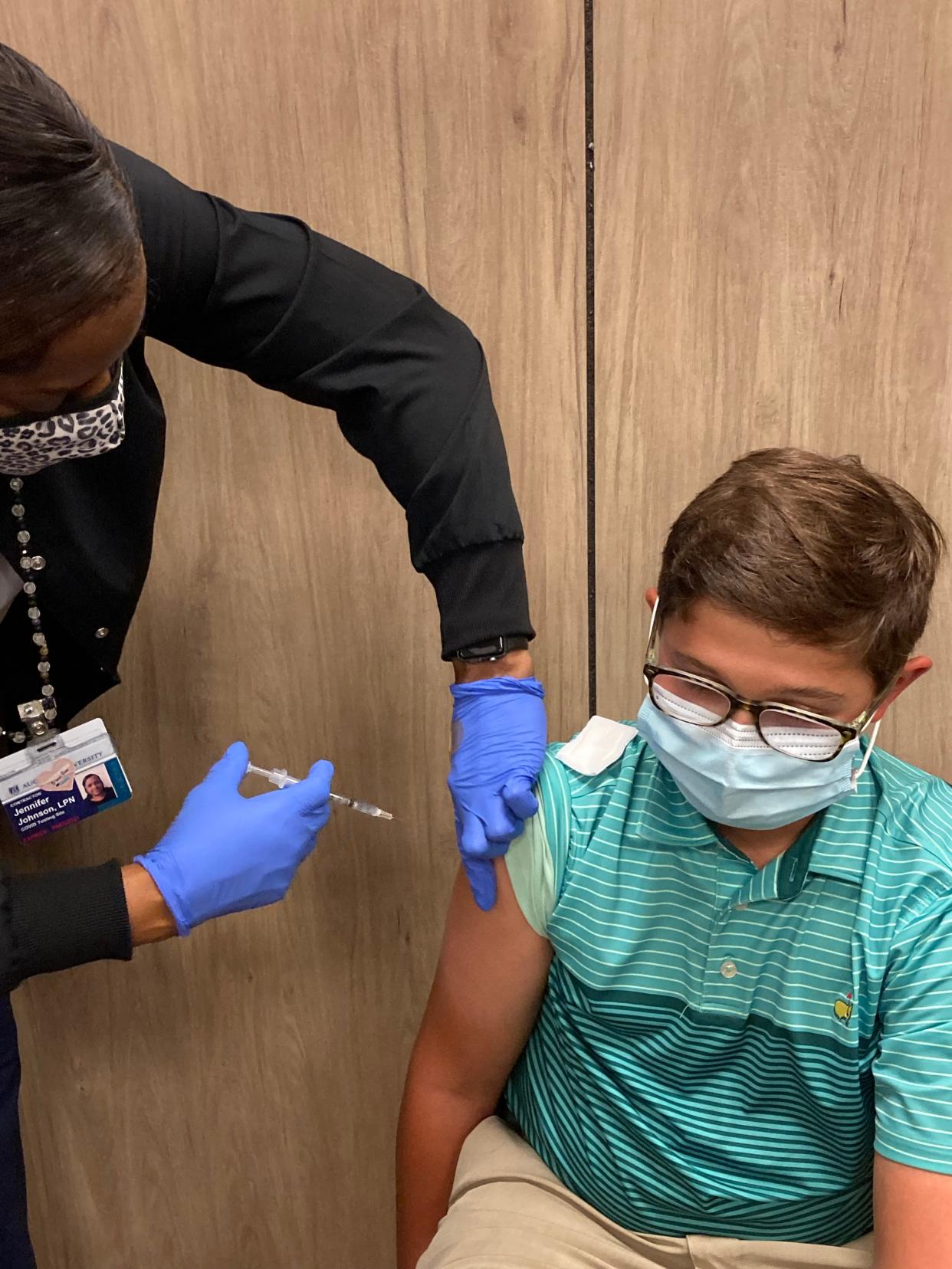 Alex Thompson, 13, of Evans, received his COVID-19 vaccination in May from nurse Jennifer Johnson at AU Health System's clinic in Washington Square in Augusta.