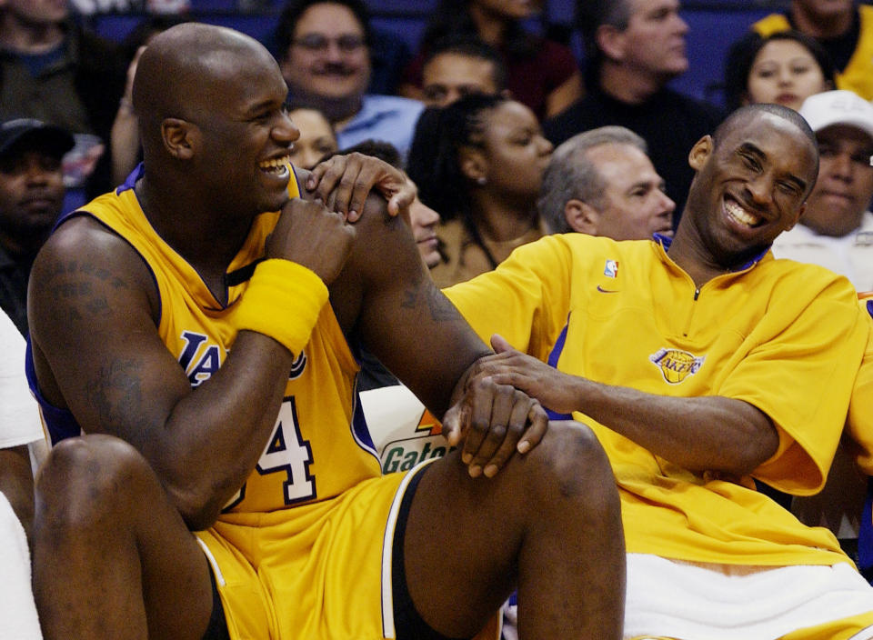 Los Angeles Lakers Shaquille O'Neal, left, and Kobe Bryant share a laugh on the bench while their teammate take on the Denver Nuggets during the fourth quarter at Staples Center in Los Angeles, April 15, 2003. Bryant, the 18-time NBA All-Star who won five championships and became one of the greatest basketball players of his generation during a 20-year career with the Los Angeles Lakers, died in a helicopter crash Sunday, Jan. 26, 2020. (AP Photo/Kevork Djansezian)