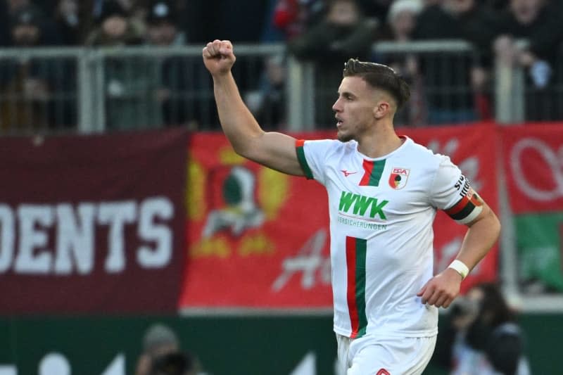 Augsburg's Ermedin Demirovic celebrates after scoring his first goal of the game during the German Bundesliga soccer match between FC Augsburg and Bayern Munich at the WWK-Arena. Sven Hoppe/dpa