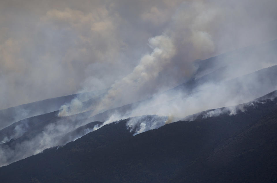 Forest fires burn across the slopes of Mount Kenya, the second-highest peak in Africa at 5,199 meters (17,057 feet), in Kenya Tuesday, March 20, 2012. Fires that have been raging across Mount Kenya may have been set by poachers trying to create a diversion from their illegal attacks on animals, a wildlife official said Tuesday. (AP Photo/Ben Curtis)