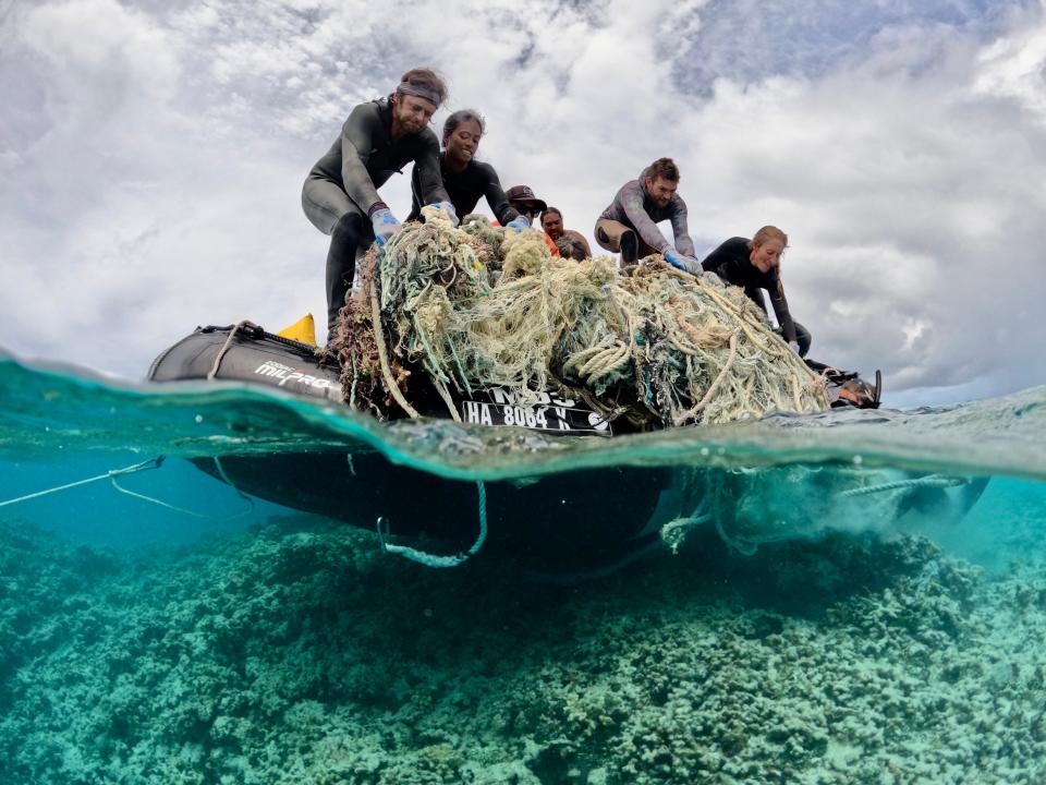 Kevin OʻBrien, Nāmele Naipo-Arsiga, Gabriela Echeverry, Kaʻehukai Goin, Derek LeVault, and Charlotte Frank work to remove a large derelict fishing net at the Papahānaumokuākea Marine National Monument.