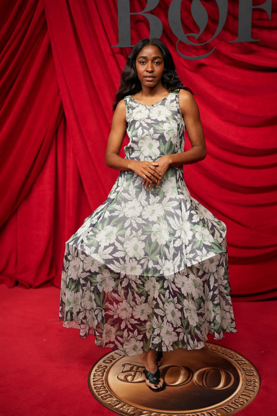 Ayo Edebiri tries on Loewe's new floral dresses for size during the Bof500 Gala (AP)