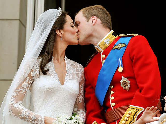 <p>John Stillwell - WPA/Getty</p> Kate Middleton and Prince William kiss following their April 2011 wedding