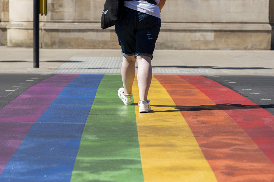 LONDON, UNITED KINGDOM - 2020/05/30: A woman uses the first permanent rainbow crossing to show support for the Wandsworth borough's LGTBQ+ community outside the iconic Battersea Arts Centre on Lavender Hill. The rainbow features the colours of the internationally recognised Pride Flag which has come to symbolise diversity and pride of the LGBTQ+ community worldwide. (Photo by Dave Rushen/SOPA Images/LightRocket via Getty Images)