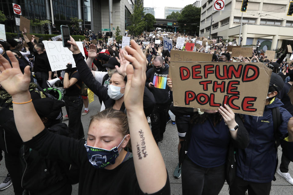 Demonstrators march toward Seattle City Hall Wednesday, June 3, 2020, in Seattle, following protests over the death of George Floyd, a black man who died in police custody in Minneapolis. (AP Photo/Elaine Thompson)