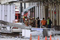 Construction workers are helped by emergency personnel after a large portion of a hotel under construction suddenly collapsed in New Orleans on Saturday, Oct. 12, 2019. Several construction workers had to run to safety as the Hard Rock Hotel, which has been under construction for the last several months, came crashing down. It was not immediately clear what caused the collapse or if anyone was injured. (Scott Threlkeld/The Advocate via AP)