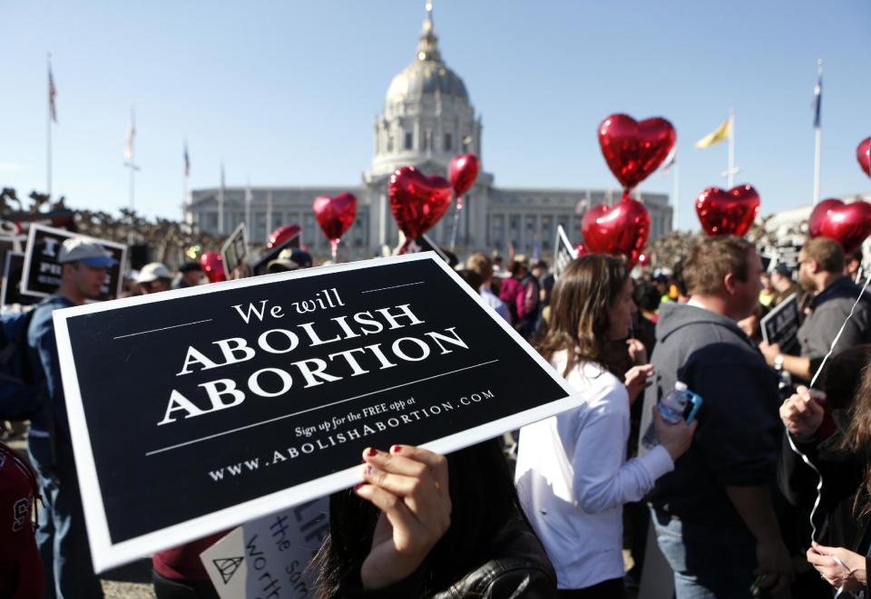 Abortion opponents gather in San Francisco's Civic Center for the "Walk for Life" rally and march, Saturday, Jan. 25, 2014, in San Francisco. Thousands of abortion opponents marched through downtown San Francisco for the 10th annual "Walk for Life West Coast." The protesters rallied at Civic Center Plaza in front of City Hall before marching down Market Street to Justin Herman Plaza. (AP Photo/Beck Diefenbach)